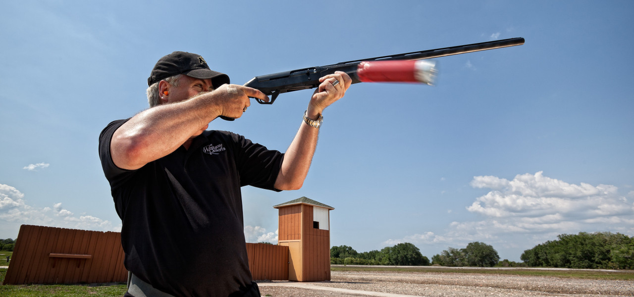 A man holding a gun up to the sky